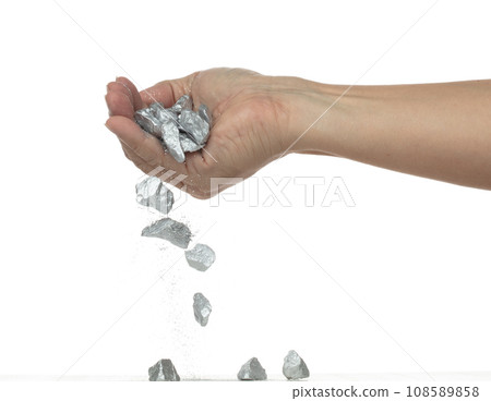 Silver ore nugget fall from industrial Miner hand fingers. Many pieces Silver nugget ore stone gravel found in hand of silver Mining industry. White background Isolated throwing freeze stop motion Silver ore nugget fall from industrial Miner hand fingers. Many pieces Silver nugget ore stone gravel found in hand of silver Mining industry. White background Isolated throwing freeze stop motion 108589858