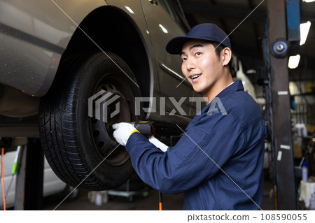 Auto mechanic inspecting a car Auto mechanic inspecting a car 108590055