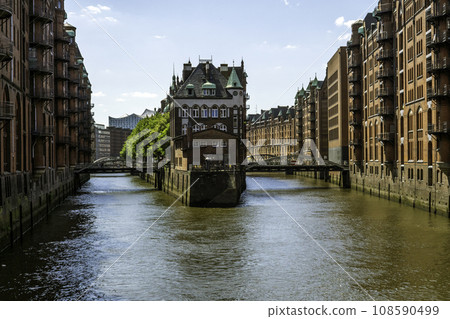The Warehouse District (Speicherstadt) in Hamburg, Germany, on sunny day. View of Wandrahmsfleet. The largest warehouse district in the world is located in the port of Hamburg within the HafenCity 108590499