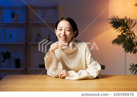 Middle-aged woman relaxing at home Middle-aged woman relaxing at home 108590878
