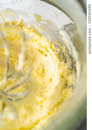 Whipping ingredients in a stand electric mixer to make dulce de leche buttercream frosting. Whipping ingredients in a stand electric mixer to make dulce de leche buttercream frosting. 108591940