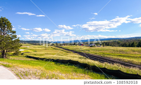 From the newly developed residential neighborhood in Colorado, a captivating view unfolds, showcasing vast farmland and a majestic mountain range in the distance, creating a picturesque and serene From the newly developed residential neighborhood in Colorado, a captivating view unfolds, showcasing vast farmland and a majestic mountain range in the distance, creating a picturesque and serene 108592018