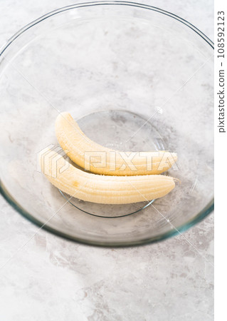 Mashing overhyped banana with a potato masher. 108592123