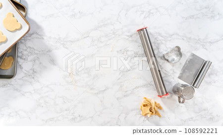 Flat lay. Rolling cookie dough and cutting out panda-shaped shortbread cookies. Flat lay. Rolling cookie dough and cutting out panda-shaped shortbread cookies. 108592221