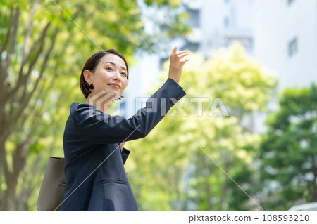 A woman raising her hand A woman raising her hand 108593210