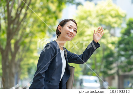 A woman raising her hand A woman raising her hand 108593213