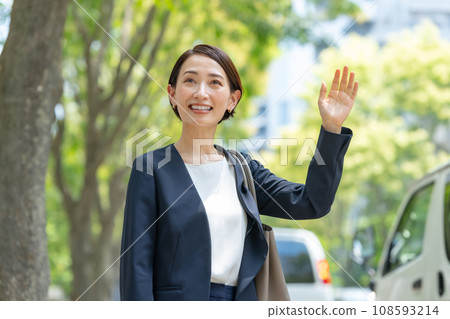 A woman raising her hand A woman raising her hand 108593214
