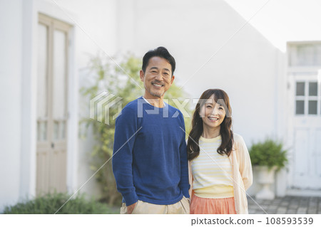 Portrait of a couple in their 50s smiling at the camera Portrait of a couple in their 50s smiling at the camera 108593539