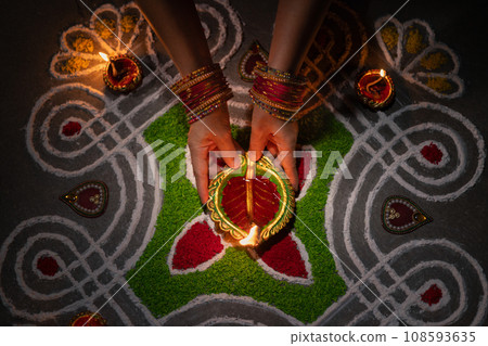 Clay diya lamps lit during diwali celebration, Diwali, or Deepavali, is India's biggest and most important holiday. Clay diya lamps lit during diwali celebration, Diwali, or Deepavali, is India's biggest and most important holiday. 108593635