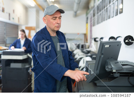 Man working in publishing facility 108594187