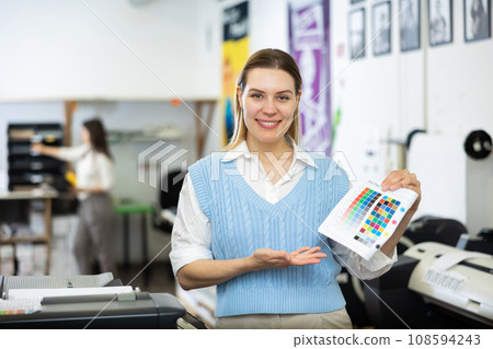 Portrait of a happy woman with color chart in her hand Portrait of a happy woman with color chart in her hand 108594243