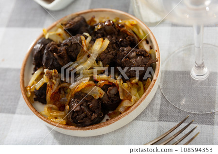 Morcilla con cebolla - traditional Spanish sausage from blood closeup Morcilla con cebolla - traditional Spanish sausage from blood closeup 108594353