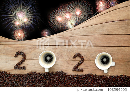 Coffee beans and hot fresh coffee in a white cup with foam and text number design 2024 for Happy New Year Concept. with fireworks background. 108594903