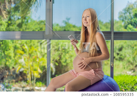In the midst of a hot day, a pregnant woman finds relief and comfort as she enjoys the cooling embrace of air conditioning, ensuring a soothing and relaxing atmosphere In the midst of a hot day, a pregnant woman finds relief and comfort as she enjoys the cooling embrace of air conditioning, ensuring a soothing and relaxing atmosphere 108595335