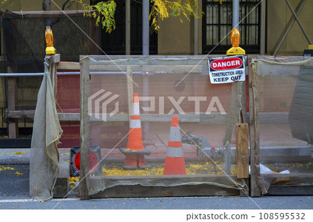 road closed sign and traffic cone in the street 108595532