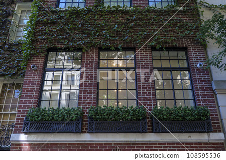 View of a Beautiful House Exterior and Front Door Seen on a Manhattan NYC View of a Beautiful House Exterior and Front Door Seen on a Manhattan NYC 108595536