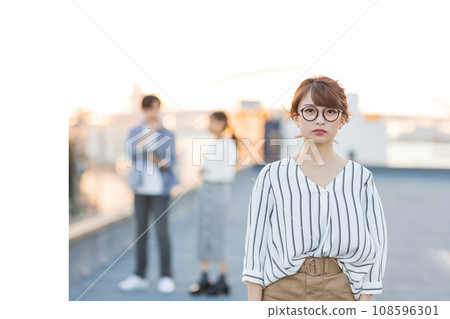 Young woman outdoors looking at camera Young woman outdoors looking at camera 108596301