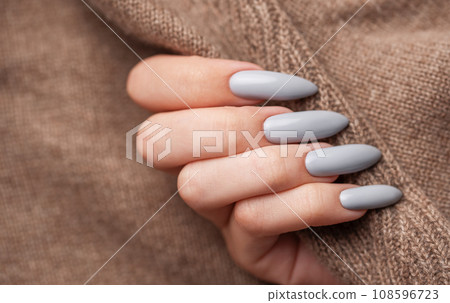 Woman's hand with grey nail polish 108596723
