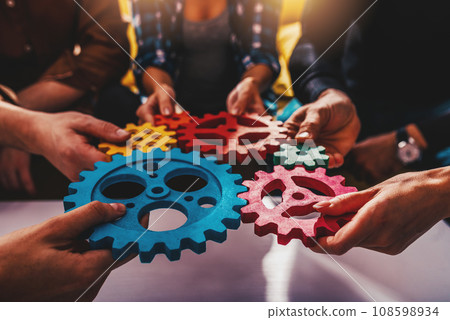 Business team work together and combine pieces of gears. Partnership and integration concept Business team work together and combine pieces of gears. Partnership and integration concept 108598934