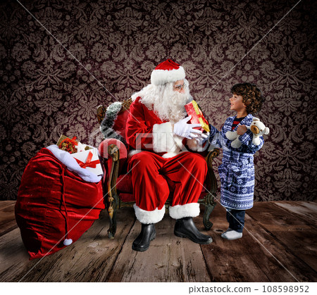 Happy santa claus is ready to deliver christmas gifts to a child 108598952