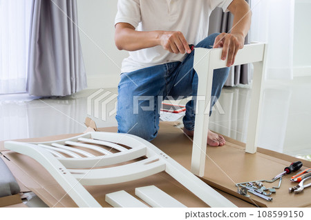 Assembly furniture using screwdriver at home 108599150