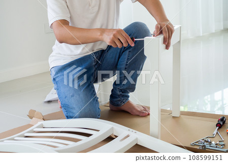 Assembly furniture using screwdriver at home 108599151
