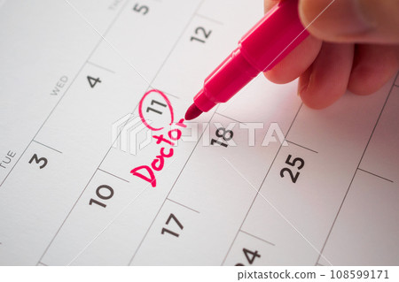 important doctor appointment schedule write on white calendar page date close up 108599171