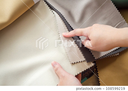 female designer with fabric color samples choosing textile for curtains female designer with fabric color samples choosing textile for curtains 108599219