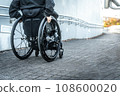 Wheelchair user climbing the slope 108600020