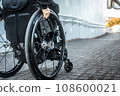 Wheelchair user climbing the slope 108600021