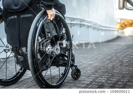 Wheelchair user climbing the slope 108600021