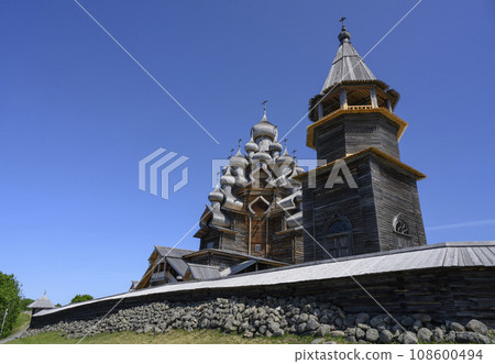 Medieval wooden bell tower and Church of Transfiguration of Lord on Kizhi Island on Onega Lake 108600494