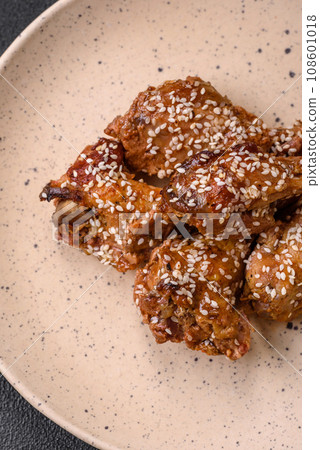 Delicious grilled chicken wings with salt, spices and teriyaki sauce Delicious grilled chicken wings with salt, spices and teriyaki sauce 108601018