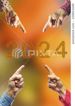 2024, People pointing to the number 2024 on orange background. Happy New Year 108601690