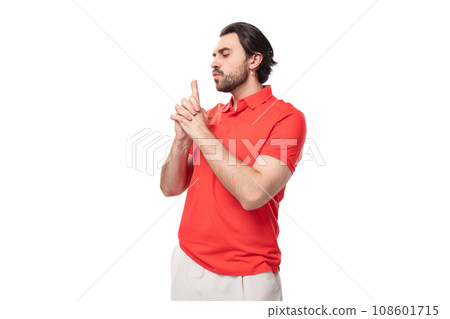 young brutal caucasian brunette man with a beard wearing a corporate color t-shirt on a studio 108601715