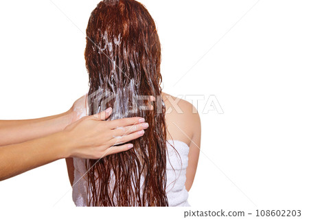 Back view. Female hands washing long hair with shampoo against white studio background. Vitamins and nutrition Back view. Female hands washing long hair with shampoo against white studio background. Vitamins and nutrition 108602203