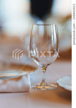 An empty wine glass on a table served for a banquet. An empty wine glass on a table served for a banquet. 108602621