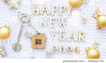 House key with keychain cottage on cozy festive knitted background with stars, bokeh. Happy New Year 2024 wooden letters, greeting card. Purchase, construction, relocation, mortgage, insurance House key with keychain cottage on cozy festive knitted background with stars, bokeh. Happy New Year 2024 wooden letters, greeting card. Purchase, construction, relocation, mortgage, insurance 108602770