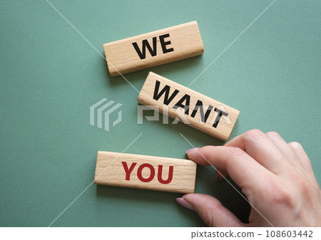 We want you symbol. Concept words We want you on wooden blocks. Beautiful grey green background. Businessman hand. Business and We want you concept. Copy space. 108603442
