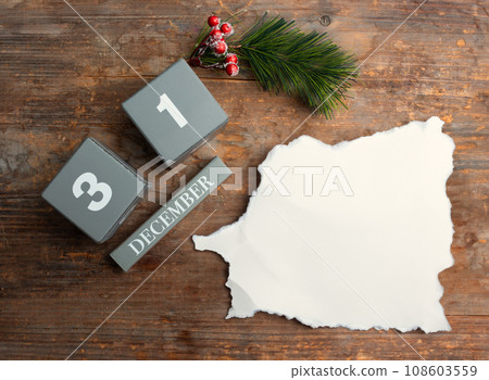 December 31st. wooden calendar with the date December 31 with New and a piece of paper for writing 108603559