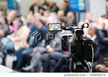 Video camera capturing businesspeople in conference meeting at export forum Video camera capturing businesspeople in conference meeting at export forum 108604074