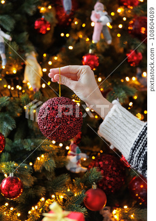 woman decorates Christmas tree and house for holiday New year 108604089