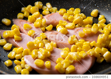Stir-fried fish sausage and corn, cooking scene. Stir-fried fish sausage and corn, cooking scene. 108604951
