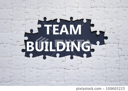 Team Building symbol. Concept word Team Building on white puzzle. Beautiful dark blue background. Business and Team Building concept. Copy space 108605225
