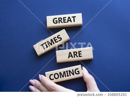 Great times are coming symbol. Concept words Great times are coming on wooden blocks. Businessman hand. Beautiful deep blue background. Business and Great times are coming concept. Copy space. 108605281