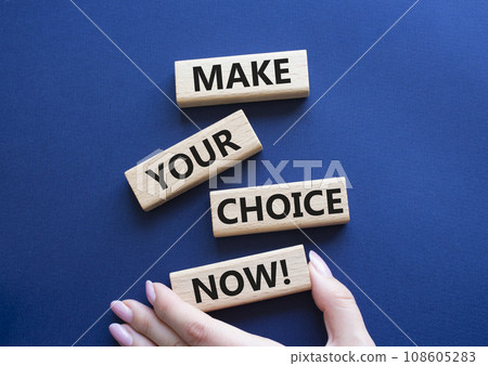 Make your Choice now symbol. Concept words Make your Choice now on wooden blocks. Beautiful deep blue background. Businessman hand. Business and Make your Choice now concept. Copy space. 108605283