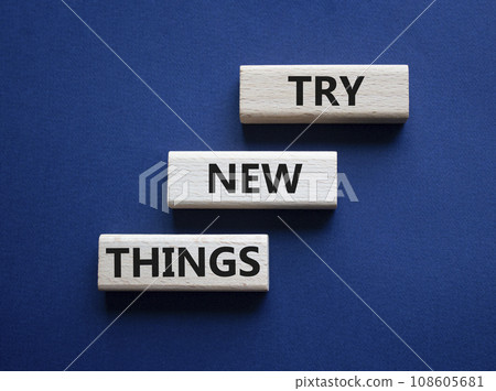 Try new Things symbol. Concept words Try new Things on wooden blocks. Beautiful deep blue background. Business and Try new Things concept. Copy space. 108605681