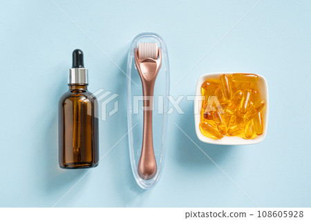 Complex treatment concept - vitamins, serum, derma roller Complex treatment concept - vitamins, serum, derma roller 108605928