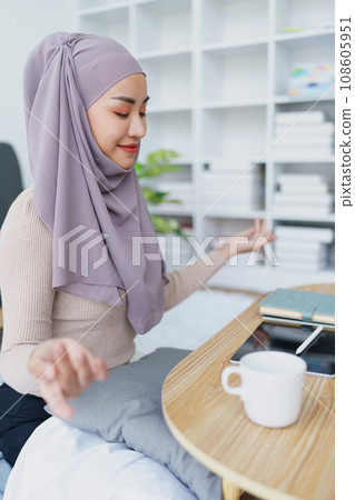 Muslim female employee Meditate while working in the office Muslim female employee Meditate while working in the office 108605951