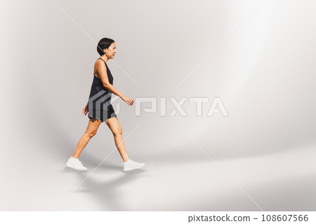 Woman exercise walking on the street hand holding bottle water. Woman exercise walking on the street hand holding bottle water. 108607566